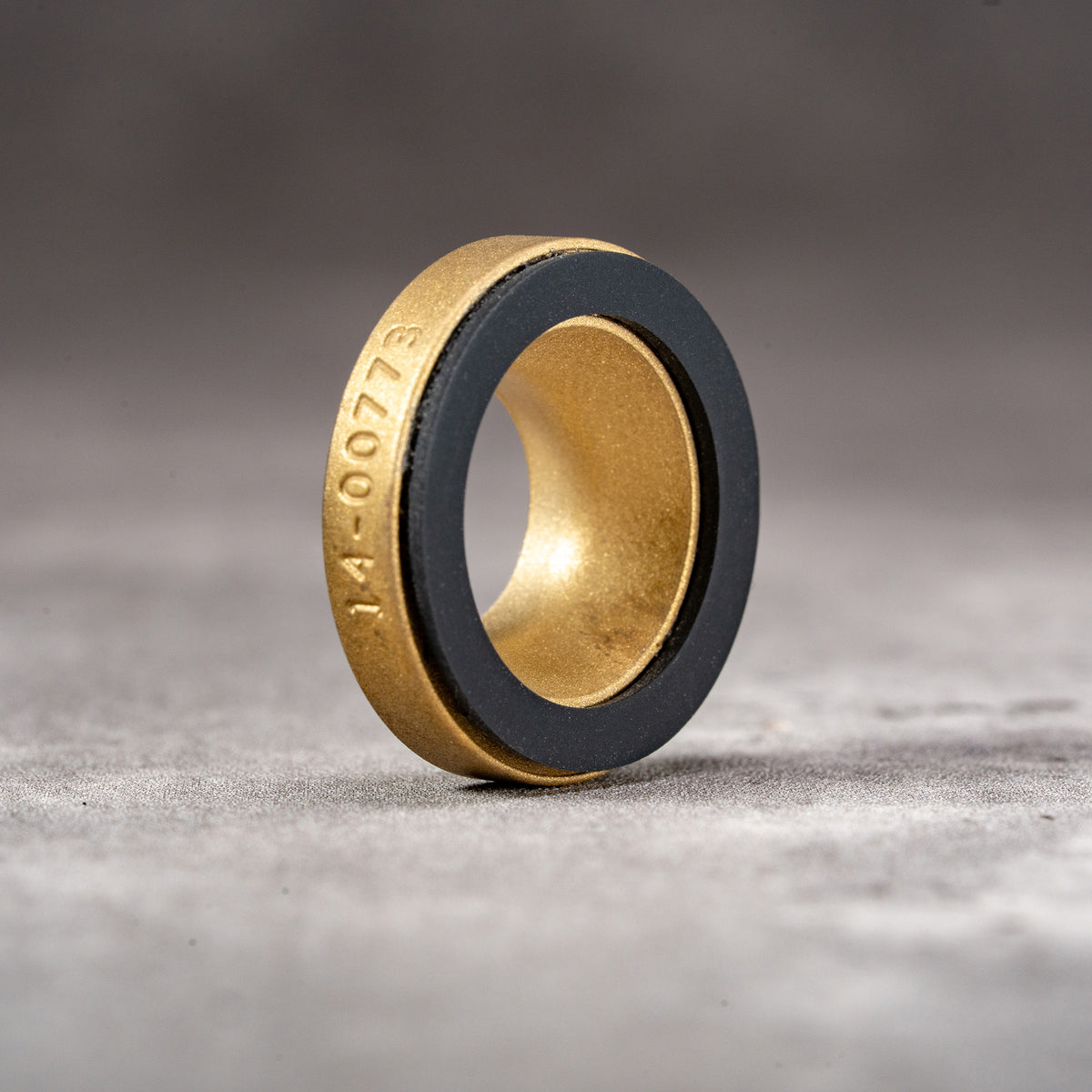 Solid Brass M-EyeKup showing the machined brass body and silicone pad