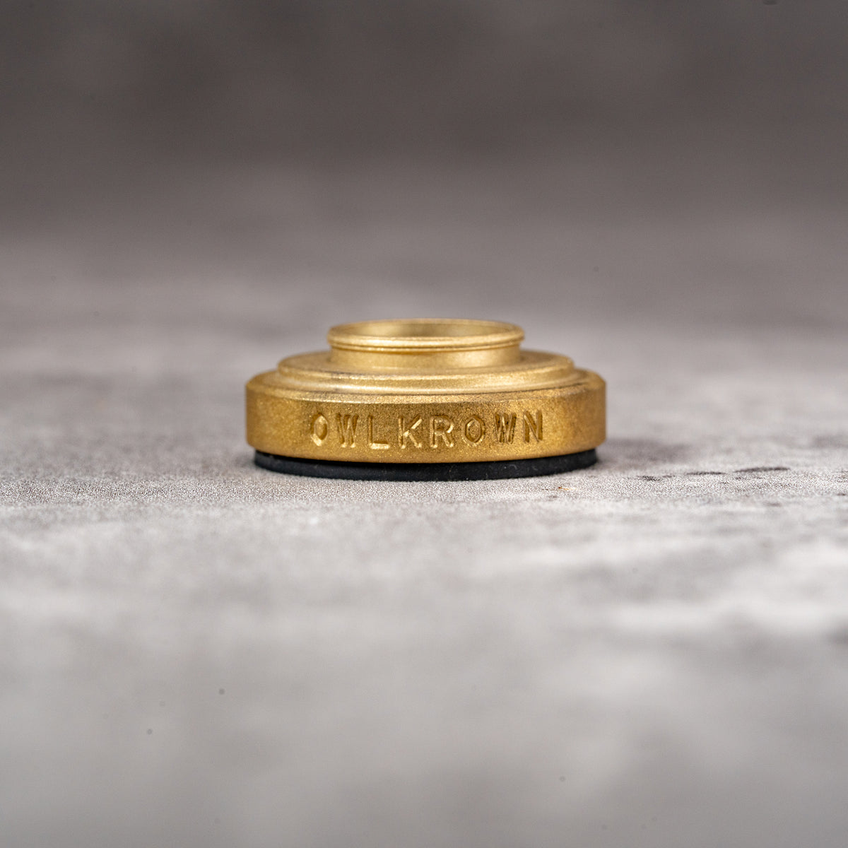 Solid Brass M-EyeKup with the Owlkrown engraving and threaded barrel visible