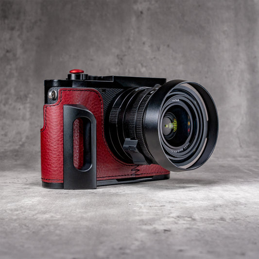 OxBlood FlexCase on a Leica Q, three quarter front, showing the red pebbled leather and the machined grip