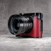OxBlood FlexCase on a Leica Q, angled front with the lens hood fitted