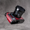 OxBlood FlexCase base plate and grip, with the strap lug slot and mounting screw visible