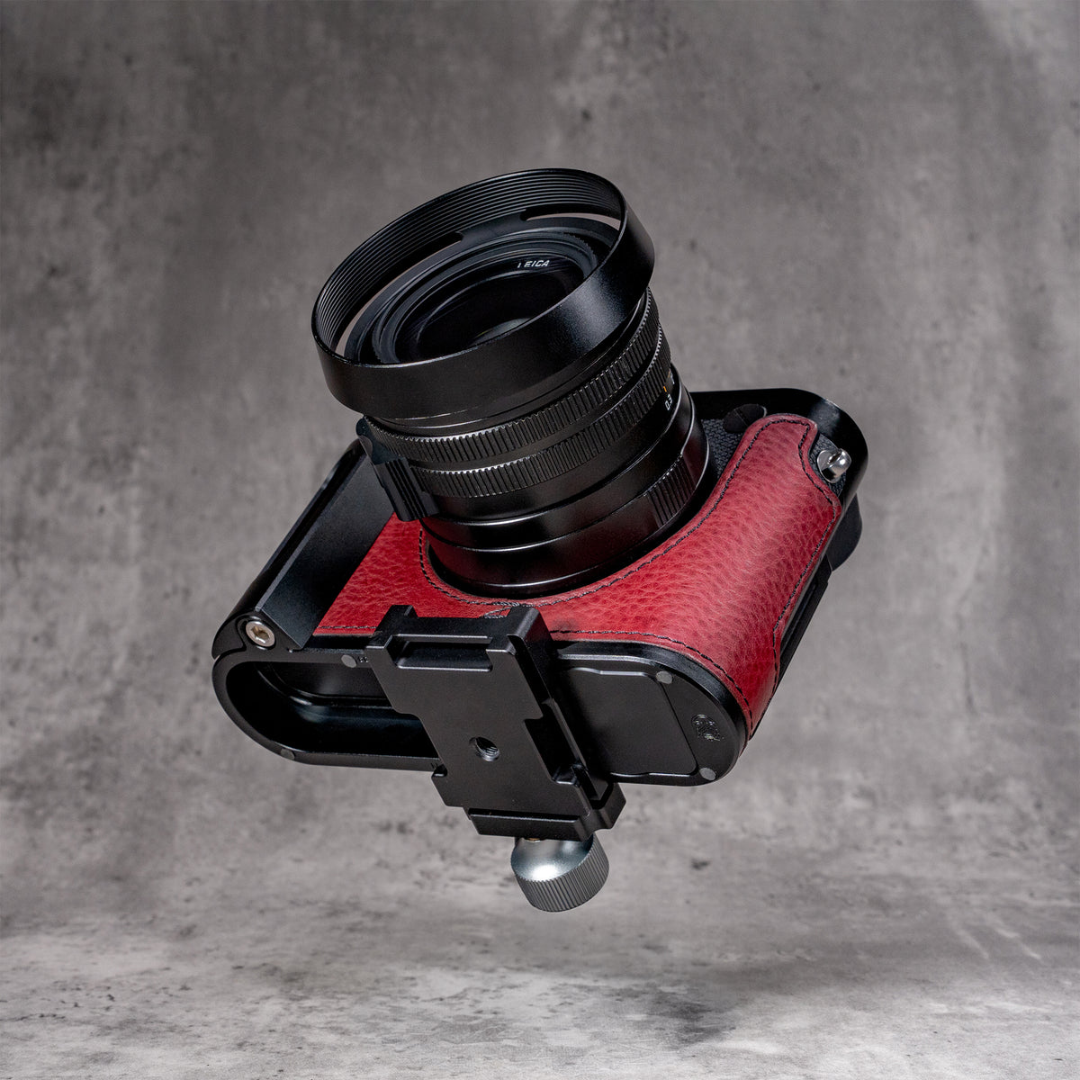 OxBlood FlexCase mounted on a tripod clamp by its concealed Arca profile
