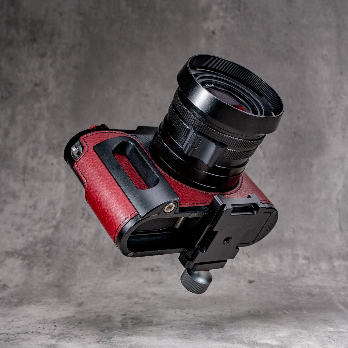 OxBlood FlexCase on a tripod clamp, showing the camera stays in the case